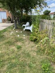 Gartenstück rechts neben dem Haus mit Apfel- und Birnenbaum, Staketenzaum bepflanzt und kleiner Wasserstelle